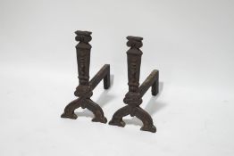 A pair of cast iron fire dogs,