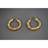 A pair of 9 carat two colour gold hoop earrings,