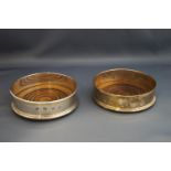 A pair of silver wine bottle coasters, London 1973, the mounts with feature hallmarks,