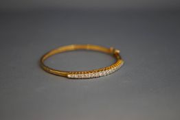 A 9 carat gold hinged diamond bangle,