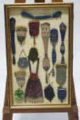 A framed collection of miser's purses, woven, beaded and metal examples,