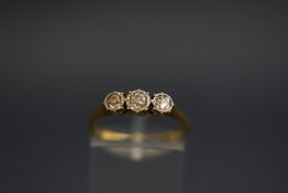 A three stone diamond ring, indistinctly stamped, the diamonds totalling approximately 0.