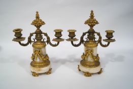 A pair of 19th century gilt metal and marble two branch candlesticks,