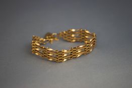 A 9 carat gold bracelet, of five bar gate link, to a padlock clasp, 9.