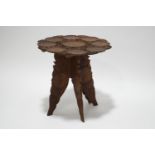 A hardwood occasional table, the top covered in low relief with lily pads,