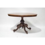 A Victorian oval walnut loo table on heavily carved column and quadruple legs,