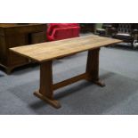 An oak refectory style table with style ends linked by a stretcher and flared feet,