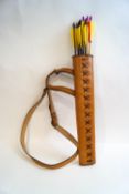A leather archery quiver with a dozen arrows and a cows horn hunting horn with plated mounts