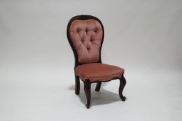 A pair of mahogany button backed nursing chairs,
