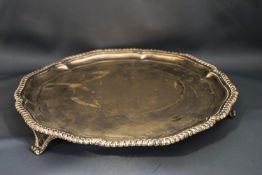 A silver salver, by Martin & Hall, Sheffield 1910, of circular shaped outline with gadrooned rim,