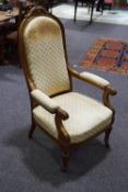 A Victorian beech showframe armchair, scroll arms and carved acanthus leaf legs,