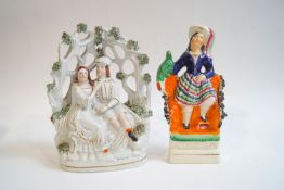 A Staffordshire earthenware figure group of a seated couple under a bocage, 20cm high,