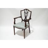 An 18th century mahogany and satinwood strung elbow chair,