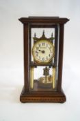 An early 20th century brass tortion clock with disc pendulum, the dial signed Benetfink & Co Ltd,