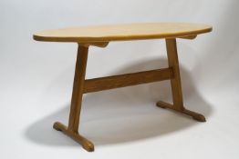 A 20th century oval dining table by John Mead, Pewsey, on stretchered base,
