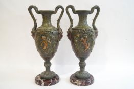 A pair of painted spelter two handled urn vases and covers,