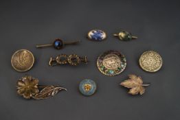 A collection of ten silver and silver coloured brooches