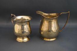 A silver mug, inscribed; and a silver cream jug; 138 g (4.