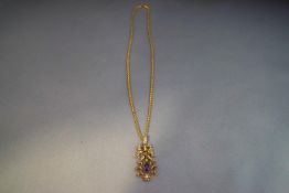 An Edwardian amethyst, demantoid garnet and seed pearl pendant,