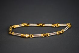 An 18 carat gold two colour gold bracelet, of double barley twist capped baton links,