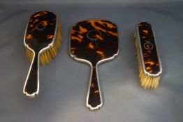 A tortoiseshell pique work and silver mounted hand mirror,