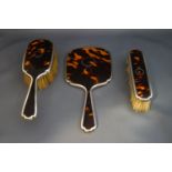 A tortoiseshell pique work and silver mounted hand mirror,