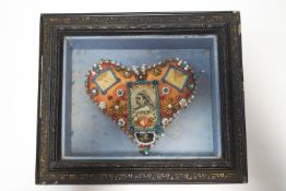 A large Victorian commemorative heart pin cushion, within a glazed case,