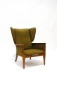 A Parker Knoll wing back armchair with green upholstery, 78cm at widest point,