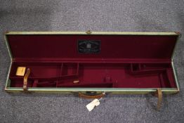 A canvas and leather bound shotgun case, with stencilled initials R M-D,
