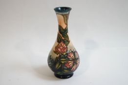 A Moorcroft vase with slender flared neck and bulbous body, tube lined,