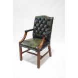 A Chesterfield style green leather office chair,