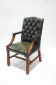 A Chesterfield style green leather office chair,