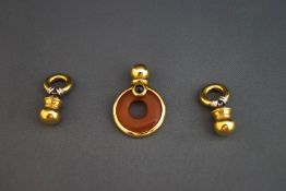 A cornelian and sapphire cabochon set pendant,