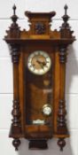 A Vienna walnut regulator style wall clock with pendulum and key,