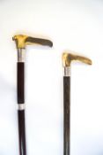 A pair of walking sticks with horn handles and silver collars, one Birmingham 1891,