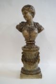 A 19th century Continental painted pottery bust of a woman on a socle and carved wooden column,