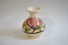 A Moorcroft vase with flared neck and bulbous body, tube lined, with the Magnolia pattern,