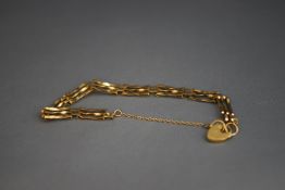 A 9 carat gold bracelet, of three bar gate link design, to a padlock clasp, 5.