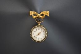 An enamel fob watch, the white enamel dial enclosed by seed pearls,