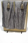 A pair of grey silk curtains and tie backs,