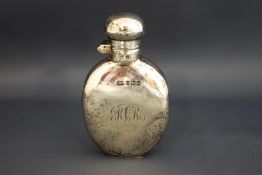 A small silver hip flask, Birmingham 1925, of flattened ovoid shape, captive bayonet top,