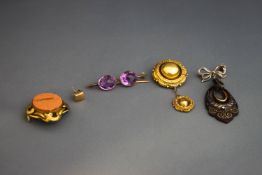 A Victorian gold locket back brooch;