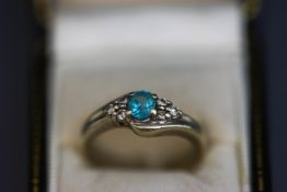 A blue topaz and diamond 9 carat white gold ring,