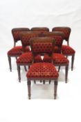 A set of six Victorian mahogany dining chairs with carved scroll and flower detail to the shaped