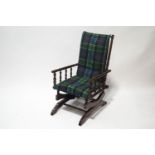 A Victorian American rocking chair with spindle sides and tartan upholstered seat and back
