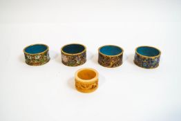 A set of four Chinese cloisonne napkin rings, and an early 20th century ivory napkin ring,