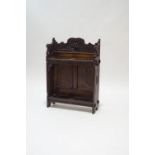 A 19th century continental oak stick stand, with carved decoration of a hunter to the back panel,