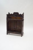 A 19th century continental oak stick stand, with carved decoration of a hunter to the back panel,