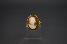 A shell cameo ring, stamped 'K18', finger size H1/2,