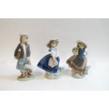 A pair of Lladro figures of girls holding baskets of flowers, 17cm high,